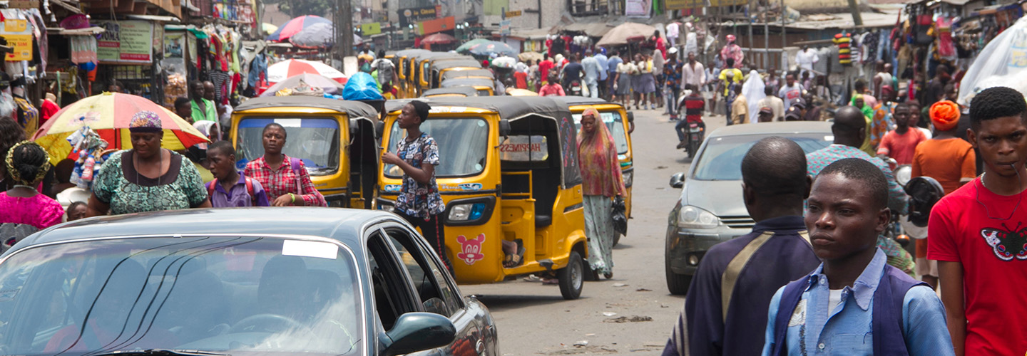 urban street filled with people and vehicles