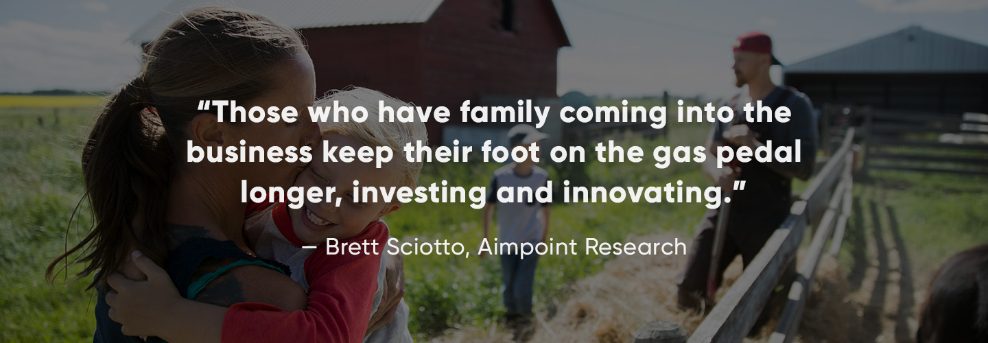 husband, wife, and two children outdoors on family farm