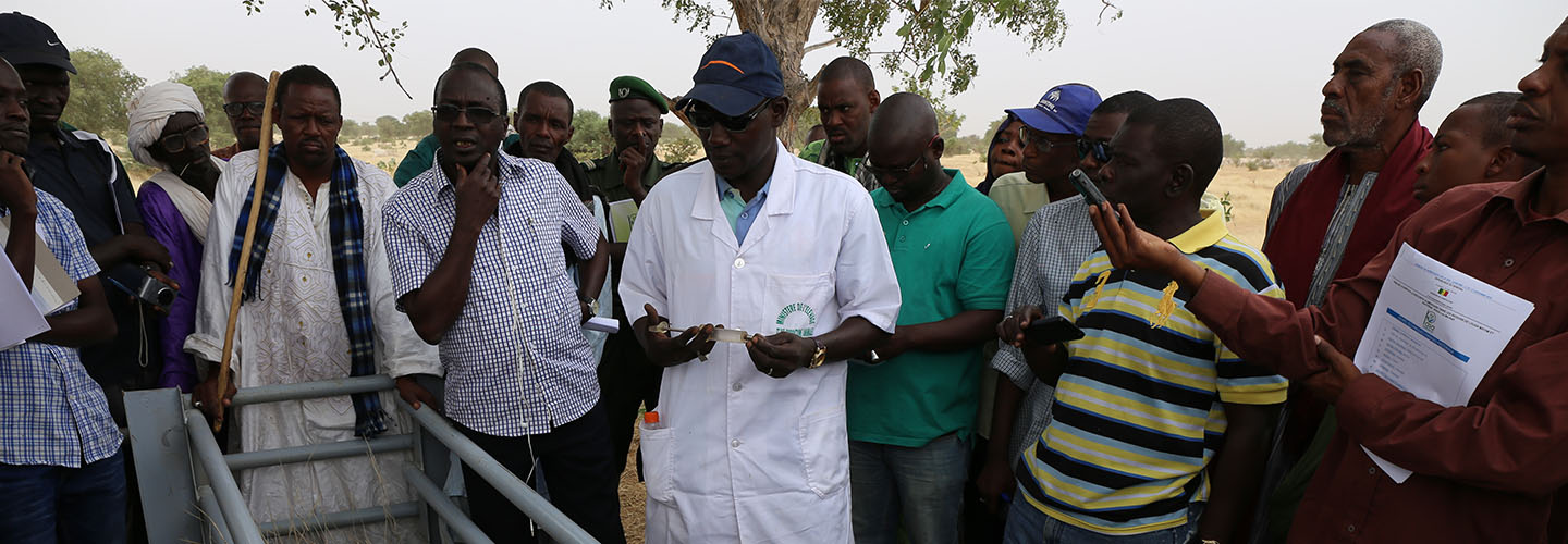 group of farmers gathered together in field